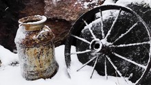 Hyper Lapse Of Snow Building Up On Vintage Wagon Wheel And Milk Tin During Blizzard