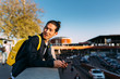 © MyMicrostock/Stocksy - Young man using smartphone outdoors
