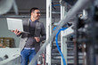 © zorandim75 - Engineer in the factory using laptop computer for maintenance automatic machine.