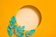 © Maki Company Limited/Stocksy - Creative layout made with leaves on bright orange background