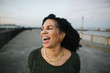 © Rob and Julia Campbell/Stocksy - Portrait of mature woman laughing outdoors