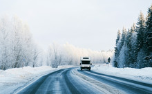 Mini Van On Winter Road With Snow In Finland. Car And Cold Landscape Of Lapland. Europe Forest. Finnish City Highway Ride. Roadway And Route Snowy Street Trip. Driving