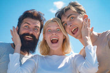 Excited group young people. Company of happy young people spend leisure outdoors at sky background. Two boys and blonde girl looking at camera and have surprised faces. Group of cheerful friends