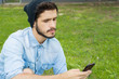 © Mego-studio - Young man using his phone. Outdoors.