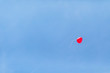 © Westend61 - Low angle view of red heart shaped balloon flying against clear blue sky at wedding ceremony