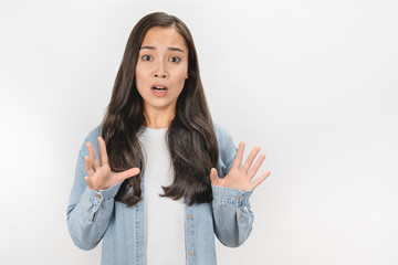 Portrait of scared young girl looking at camera isolated over white background