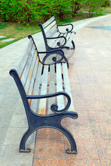 Wall Mural - Wooden chairs in parks and distant buildings