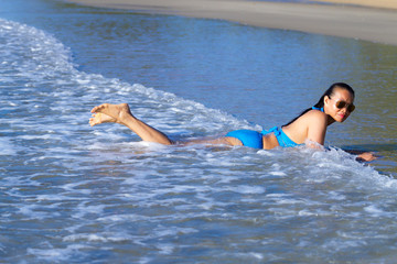 Woman and bikini blue relax with wave at the beach