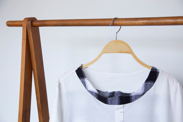 Woman blouse with white blouse cotton on wooden hangers