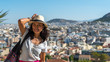 Asian woman in white t-shirt in Athens holding her hat