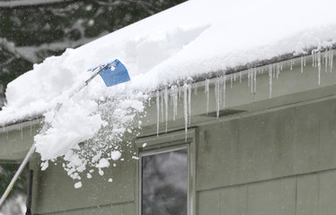 Wall Mural - removing snow on the roof after snow storm