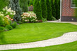 Leinwandbild Motiv Freshly cut grass in the backyard of a private house.