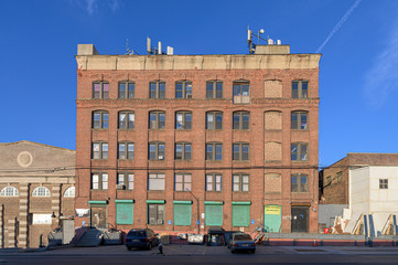 Old-fashioned brickwall factory building against a blue sky on a beautiful sunny day in the Bronx, New York