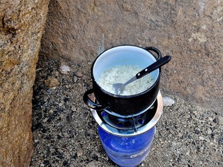 cooking some rice with a gascooker. camping life in namibia at spitzkoppe campsite