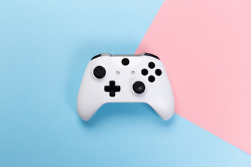 White joystick gamepad, game console on pink and blue background. Computer gaming technology play competition videogame control confrontation concept. Cyberspace symbol