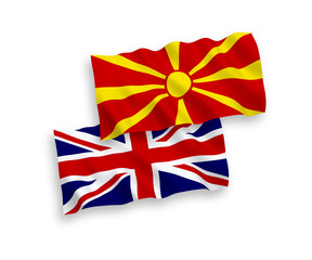 National vector fabric wave flags of Great Britain and North Macedonia isolated on white background. 1 to 2 proportion.