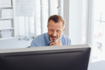 Wall Mural - Businessman working at a desktop computer