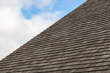 Grey Slate Roof With Cloudy Blue Sky Background