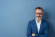 © contrastwerkstatt - Confident middle-aged man with arms folded