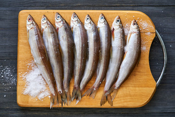 Canvas Print - Raw vendace with salt on a wooden board