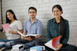 © torwaiphoto - Group students asian brainstorming reading books