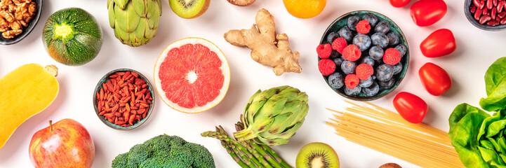 Vegan food panoramic flatlay shot. Healthy diet concept. Fruits, vegetables, pasta, nuts, legumes on a white background