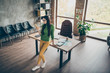 © deagreez - Full length high angle view photo of pretty business lady chatting telephone partners hard-working person wear green turtleneck yellow trousers leaning table modern interior office