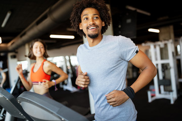 fit group of people exercising on a treadmill in gym