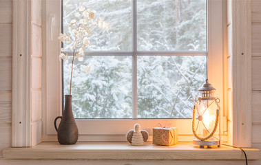 Beautiful burning candles and fairy lights on windowsill indoors