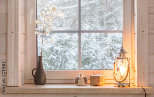 Beautiful Burning Candles And Fairy Lights On Windowsill Indoors