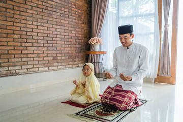 Wall Mural - father teach her toddler to pray. muslim parent and kid