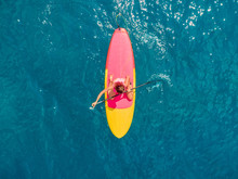 Attractive Woman In Swimwear Floating On Stand Up Paddle Board On A Quiet Blue Ocean. Sup Surfing In Tropical Sea