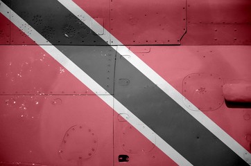 Trinidad and Tobago flag depicted on side part of military armored helicopter closeup. Army forces aircraft conceptual background