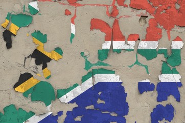 south africa flag depicted in paint colors on old obsolete messy concrete wall closeup. textured ban