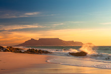 Scenic View Of Table Mountain Cape Town South Africa From Blouberg At Golden Sunset With Splashing Waves