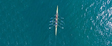 Aerial Drone Top Panoramic View Of Sport Canoe Rowing Synchronous Athletes Competing In Tropical Exotic Lake