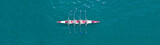 Aerial drone top panoramic view of sport canoe rowing synchronous athletes competing in tropical exotic lake