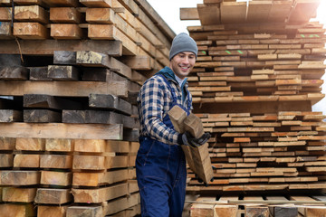 Wall Mural - Young male worker in timber warehouse 