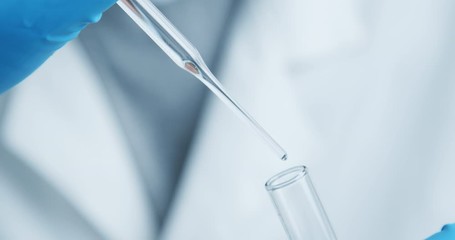 Wall Mural - crop shot of technician carefully drips the solution from the pipette into glass tubes for dna analy