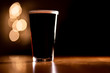 Pint of Dark Stout Beer on a Wooden Table with Copy Space