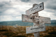 Count Your Blessings Text On Wooden Rustic Signpost Outdoors In Nature/mountain Scenery.