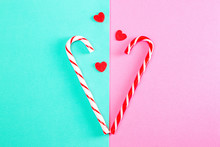 Christmas Sweets Connected In The Shape Of A Heart With Three Tap Small Hearts Pink-turquoise Background. Modern Creative Minimal Image. Symbol Of Love.