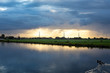 © misign - Bright sunrays shine on the high poles of the electricity grid through the village of Nieuwe Wetering.