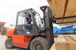 © pikselstock - Young male worker driving forklift in lumber yard