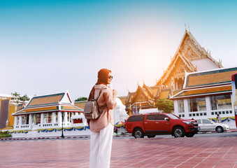 Back view of muslim Woman tourist walking in the buddha temple, Bangkok, popular famous location of city travel destination. Travel concept.