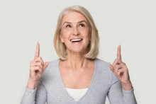 Happy Mature Woman Look Up Showing Up With Fingers Portrait