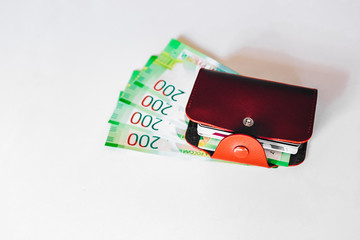 brown leather wallet with plastic cards and Bank of Russia banknotes. Russian money for 200 rubles