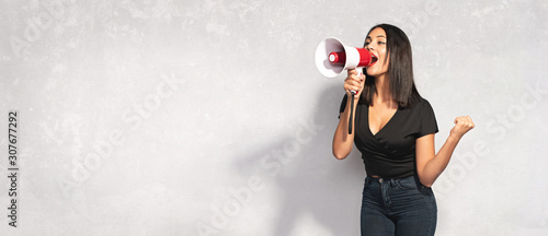 Cuadros en Lienzo Beautiful Brunette Woman Shouting Through Megaphone