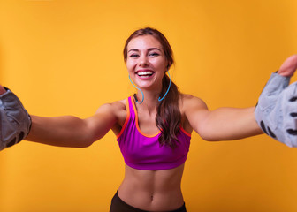 Wall Mural - Image of a positive young brunette sports fitness woman posing isolated over white wall background take selfie by camera showing peace gesture.Attractive girl making a selfie after her exercise.