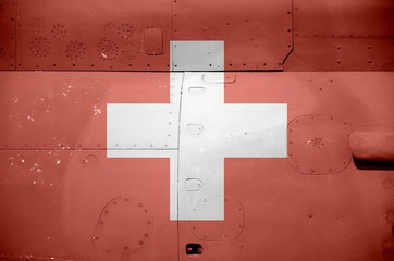 Switzerland flag depicted on side part of military armored helicopter closeup. Army forces aircraft conceptual background